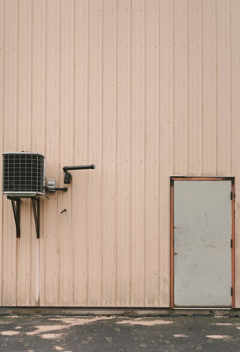 wall gray air condenser beside gray closed door minerva